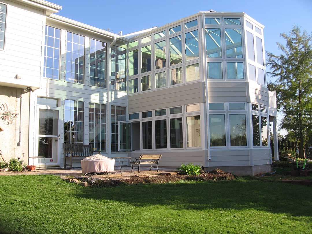 large sunroom expanding to top of second story of home
