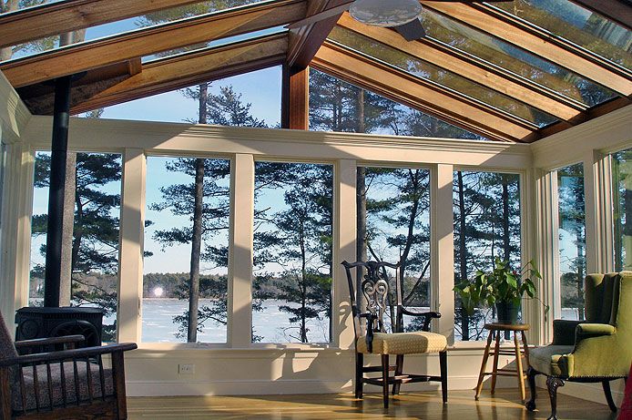 interior of spacious sunroom with peaked ceiling
