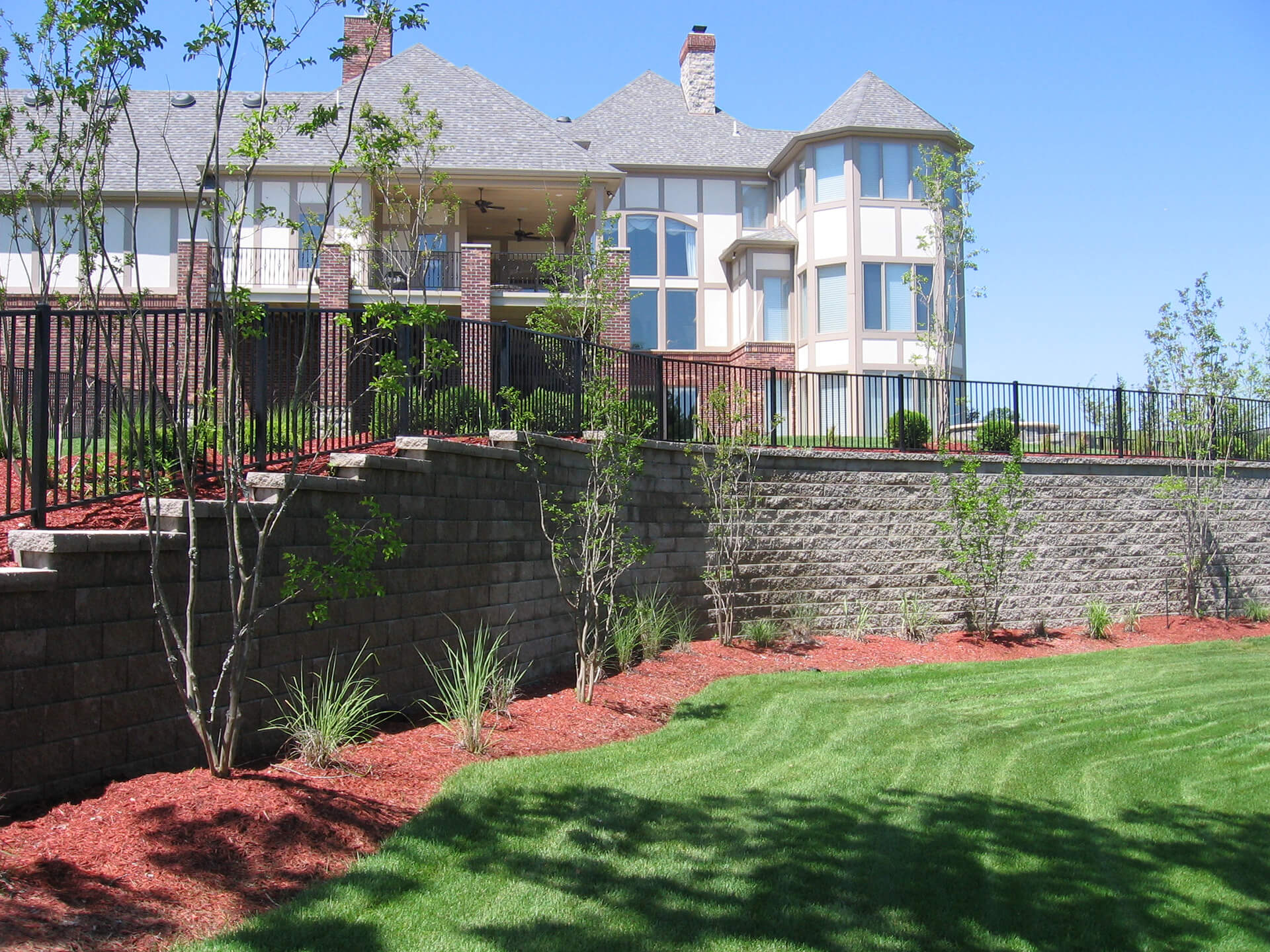 aluminum fence in front of large home